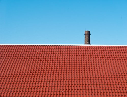 Terracotta tile roof against blue sky